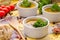 Homemade sausage soup with parsley in white ramekin bowls