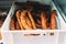 Homemade sausages on a farmers market. Traditional street food. Tasty delicious smoked dried sausages at plastic box. Traditional