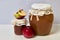 Homemade seasonal preparations. Beautifully packaged jars of apple jam. Covered with paper and tied with a cord. Nearby are fresh