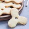 Homemade shortbread cookies made in trendy spinner toy form and a glass of milk, square