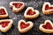 Homemade shortbread heart cookies on black background.