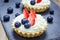 Homemade shortbread tartlets with custard cream, strawberry and blueberry
