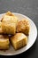 Homemade Sliced Cornbread Ready to Eat on a white plate on a black background, low angle view. Copy space