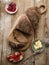 Homemade sliced rye bread on a wooden table and a sandwich with