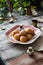 Homemade small round ball donuts sprinkled with powdered sugar on vintage plate