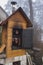 Homemade smokehouse in the morning mist. Domestic production of sausages. Smokehouse at the house in the woods