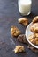 Homemade soft apple cookies on a plate with milk, dark concrete background. Dessert or breakfast for children, sweet snack.