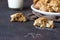 Homemade soft apple cookies on a plate with milk, dark concrete background. Dessert or breakfast for children, sweet snack.