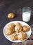 Homemade soft apple cookies on a plate with milk, dark concrete background. Dessert or breakfast for children, sweet snack.