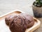 Homemade soft dark chocolate brownie cookies placed on a wooden plate. The cookies is look good and delicious. The dark chocolate