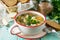 Homemade soup with buckwheat and pasta dumplings on the kitchen table