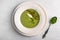 Homemade soup puree of green peas, coconut milk with tuil and cheese quenelle