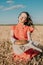 Homemade sourdough Bread Recipe. Homemade Artisan Bread in woman hands on wheat field background. Round bread in female