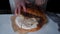 Homemade sourdough bread, woman cuting loaf bread