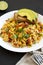 Homemade southwestern egg scramble with toast on a white plate on a black surface, side view. Close-up