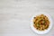 Homemade southwestern egg scramble on a white plate on a white wooden surface, top view. Flat lay, overhead, from above. Copy