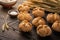 Homemade spelt bread rolls with salt on wooden background