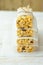 Homemade stacked muesli cereal bar with oats, nuts, raisins, honey and dried apples. Lined with parchment paper, tied with twine