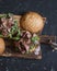 Homemade steak burger on wooden cutting board