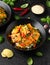 Homemade Stir Fry Tofu with Vegetables and Rice in black bowl