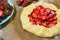 Homemade strawberry Galette with fresh ripe strawberries on a dark background