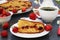 Homemade strawberry pie is located on a dark background on a white plate