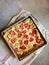 Homemade strawberry-rhubarb clafoutis dessert in square aluminum pan