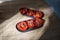 Homemade sun-dried tomatoes, kitchen still life tomatoes with spices in bright sunlight with hard shadow