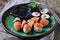 Homemade sushi with wild salmon, shrimp, cucumber and seaweed. selective focus