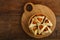 Homemade sweet gometashi cookies for Purim laid out on a wooden board in a bread basket.copy space.