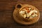 Homemade sweet gometashi cookies for Purim laid out on a wooden board in a bread basket.copy space.