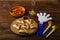 Homemade sweet gometashi cookies for Purim laid out on a wooden board next to clappers and a whistle.