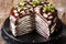 Homemade sweet sliced chocolate crepes cake with whipped cream a