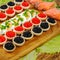 Homemade tartlets with red and black caviar, salmon, lettuce and