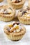 Homemade tarts with dried fruits on checked table cloth