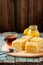 Homemade tasty layered lemon cake with tea and lemon curd on shabby wooden background