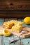 Homemade tasty layered lemon cake with tea and lemon curd on shabby wooden background