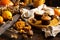 Homemade tasty sweet orange pumpkin muffins or cupcakes with white cream, lavender, zest, nuts