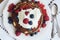 Homemade thin pancakes with whipped cream and fresh berries