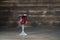 Homemade tincture of red cherry in a wine crystal glass on wooden background, Ukraine