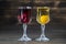 Homemade tincture of red cherry and yellow cherry plum in a wine crystal glasses on wooden background, Ukraine