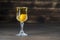 Homemade tincture of yellow cherry plum wine crystal glass on wooden background, Ukraine, close up