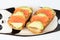 Homemade toast sandwich with salmon and avocado on a slice of cereal bread. The toast lies on a plate in the shape of a black and