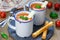 Homemade tomato basil soup in the mug, served with mozzarella cheese stick