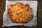 Homemade tomato and cheese pizza on a wooden table in a rustic kitchen. Traditional pizza background.