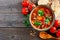 Homemade tomato, lentil soup, above view corner border on wood