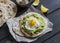 Homemade tortilla with mashed avocado and a fried quail egg.