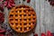 Homemade traditional autumn raspberry tart pie with jam on vintage table background. Rustic style and natural light.