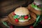 Homemade traditional burgers with beef,radish,lettuce, served on wooden background.