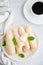 Homemade traditional Italian cookies Ladyfingers savoyardi on a white plate on a light stone background. Biscuits for tiramisu.